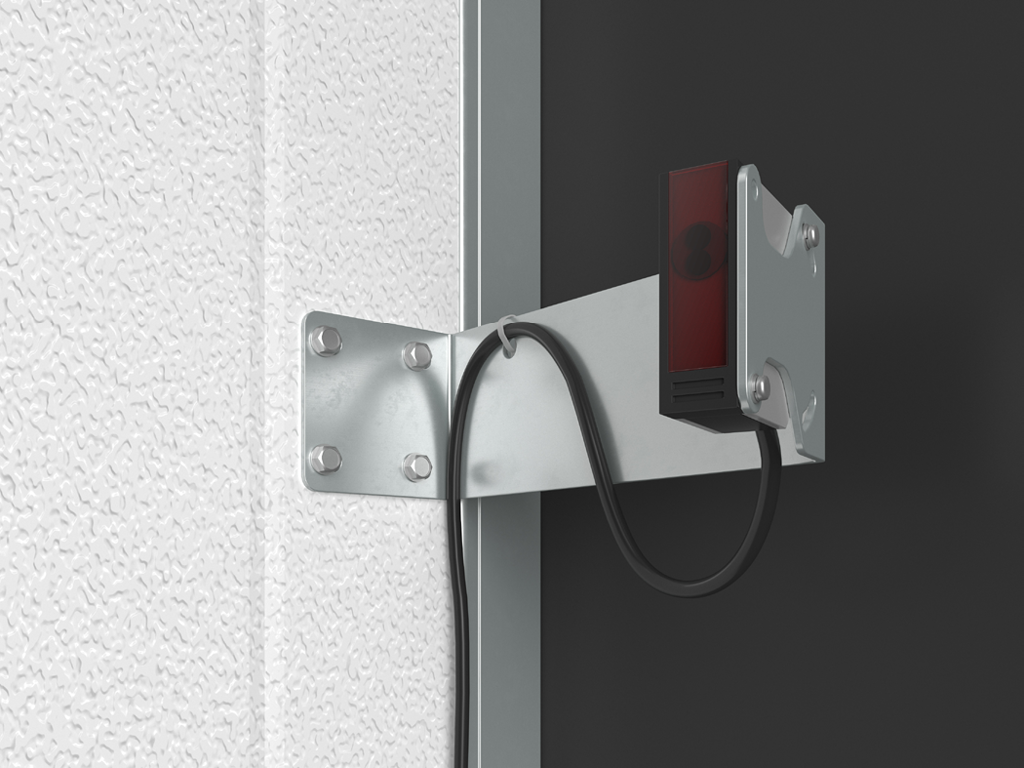 Артикул «123-626». Сенсор фотоэлектрический с кронштейном, предназначен для определения присутствия автомобиля в доке. При отсутствии автомобиля датчик обеспечивает блокировку ворот. В случае непреднамеренного откатывания автомобиля от дока, срабатывает сирена безопасности и внутренний светофор переключается на красный цвет (при условии, что дополнительная комплектация была приобретена и подключена к системе).